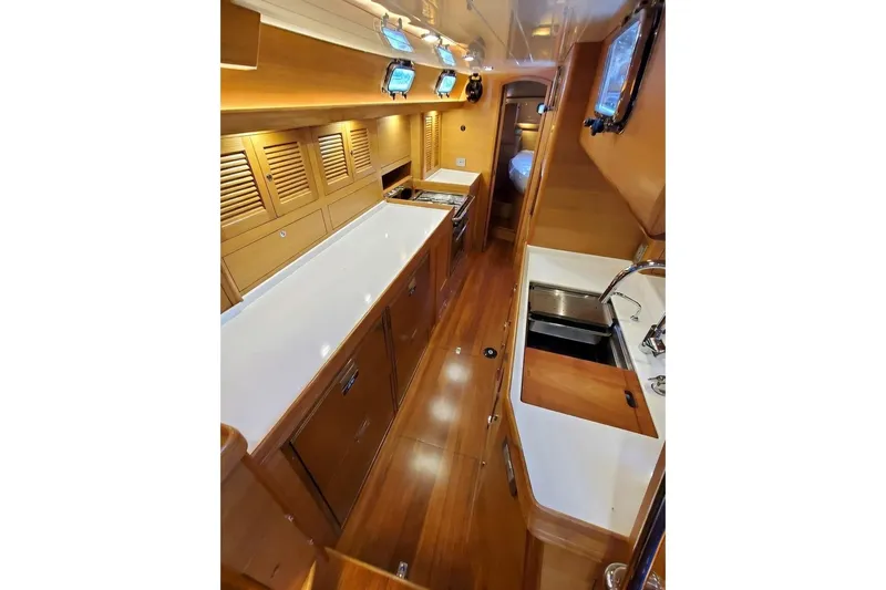 Slide: The Image of Cockpit view of 2023 Bluewater 56 sailboat with navigation instruments displaying speed and wind data. - 23