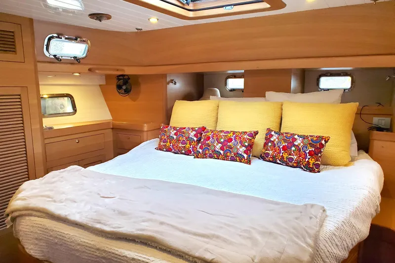 Slide: The Image of Luxurious interior of 2023 Bluewater 56 yacht with elegant wood finish and cozy seating. - 28