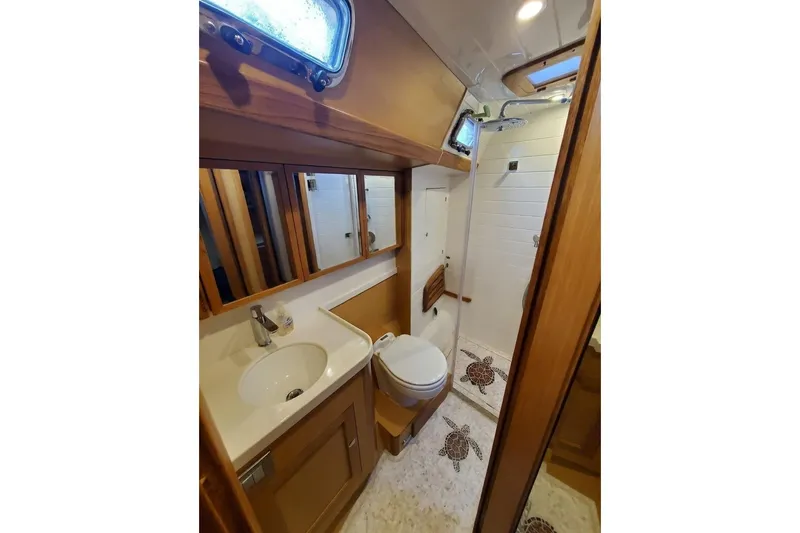Slide: The Image of Luxurious 2023 Bluewater 56 yacht kitchen with wooden cabinetry and modern appliances. - 35