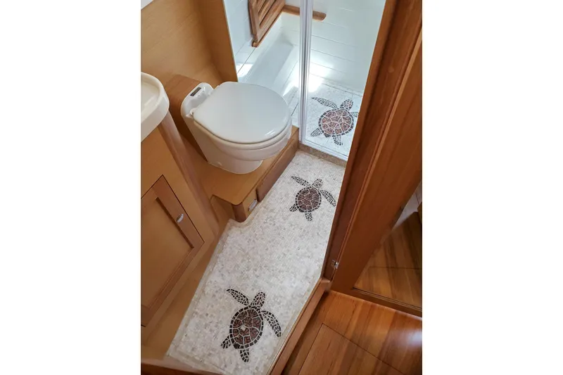 Slide: The Image of Modern kitchen area in 2023 Bluewater 56 yacht with wooden cabinetry and stainless steel sink. - 36