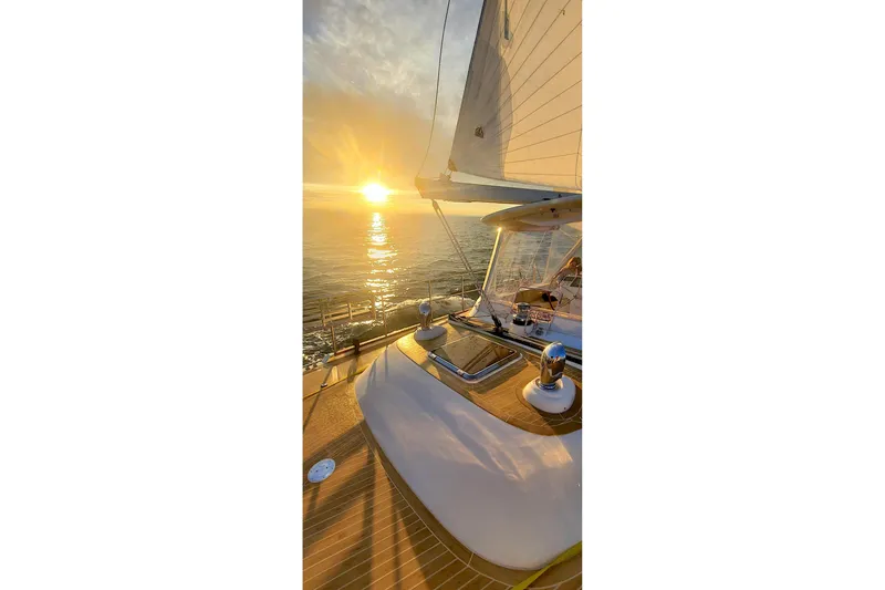 Slide: The Image of 2023 Bluewater 56 yacht sailing on open sea under clear blue skies. - 5