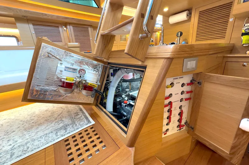 Slide: The Image of Engine room of 2023 Bluewater 56 yacht, featuring a Yanmar engine and ventilation system. - 51