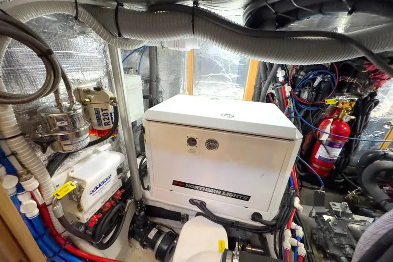 Slide: The Image of Engine compartment of 2023 Bluewater 56 yacht, showcasing hoses and mechanical components. - 56