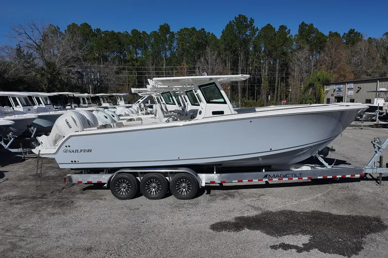 Slide: The Image of 2026 Sailfish 312 CC boat on trailer, parked outdoors, side view. - 0