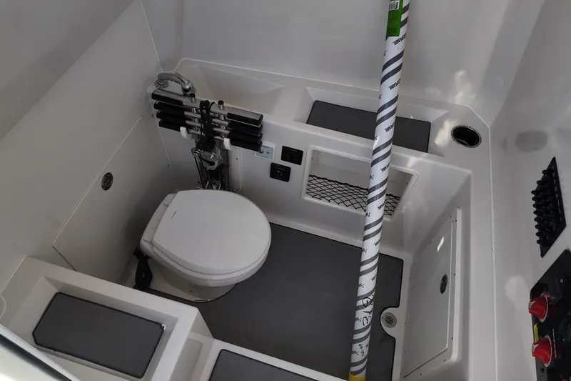 Slide: The Image of Interior of 2026 Sailfish 312 CC boat featuring a compact marine toilet. - 13