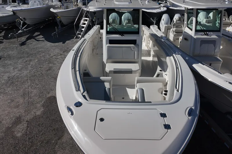 Slide: The Image of 2026 Sailfish 312 CC boat, spacious deck, modern design, parked among other boats. - 4