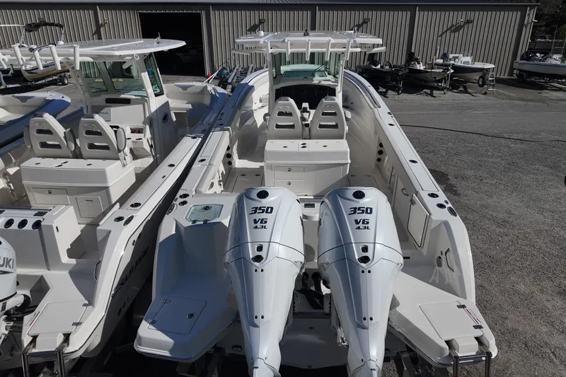 Slide: The Image of 2026 Sailfish 312 CC boat with dual 350 V6 engines, docked outdoors. - 8