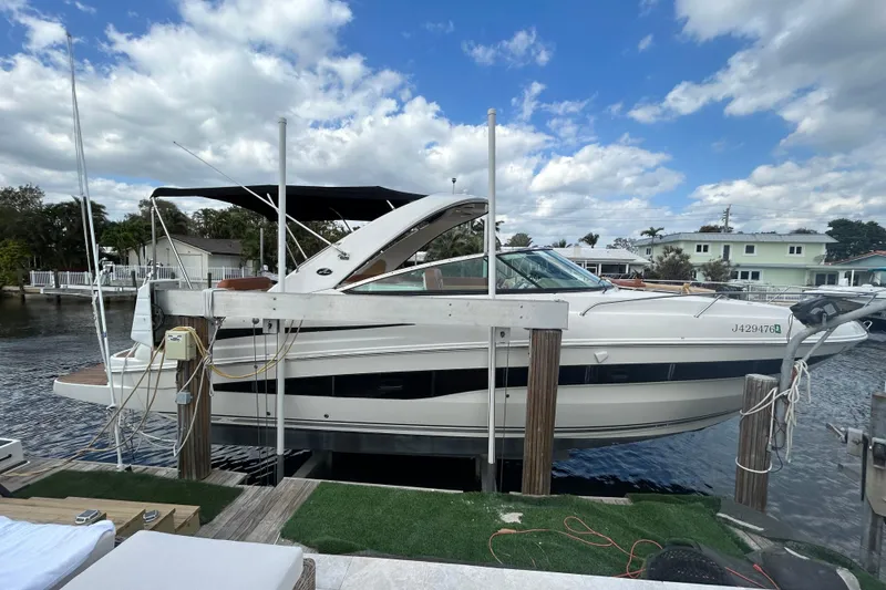 Slide: The Image of 2014 Sea Ray 370 Venture boat docked under a partly cloudy sky. - 14