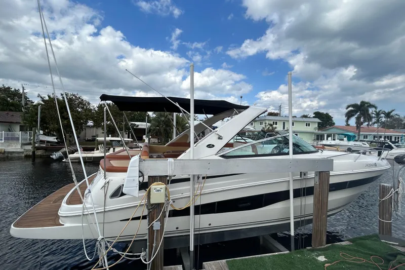 Slide: The Image of 2014 Sea Ray 370 Venture docked under a partly cloudy sky. - 15