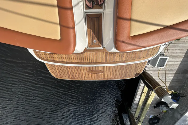 Slide: The Image of 2014 Sea Ray 370 Venture boat with teak deck and cushioned seating at dock. - 18