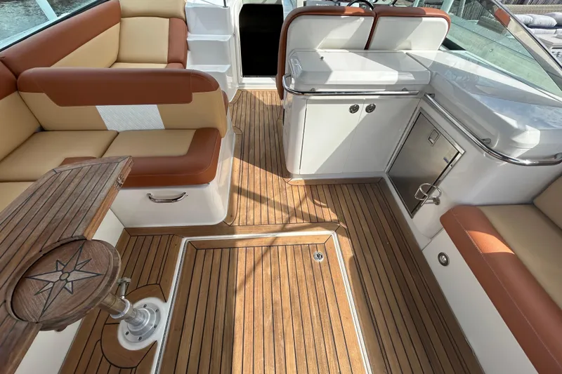 Slide: The Image of Luxurious 2014 Sea Ray 370 Venture boat interior with teak flooring and plush seating. - 19