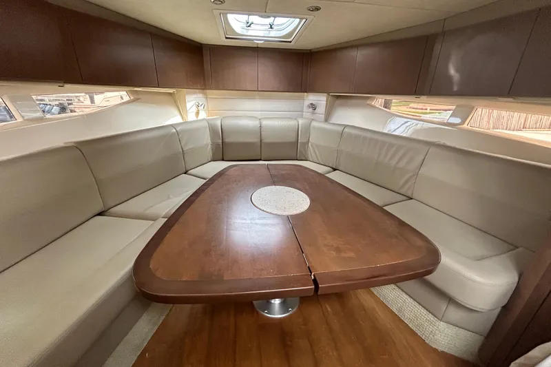 Slide: The Image of Luxurious interior of 2014 Sea Ray 370 Venture yacht with spacious seating and wooden table. - 23