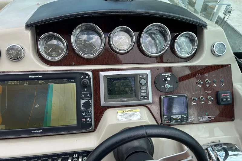 Slide: The Image of 2014 Sea Ray 370 Venture dashboard with navigation and control instruments. - 29
