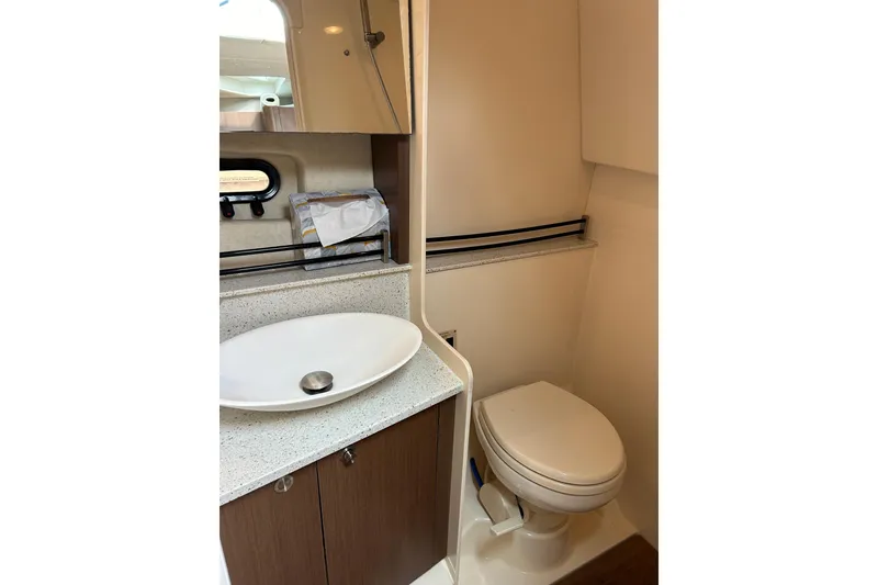 Slide: The Image of 2014 Sea Ray 370 Venture bathroom with modern sink and toilet. - 30