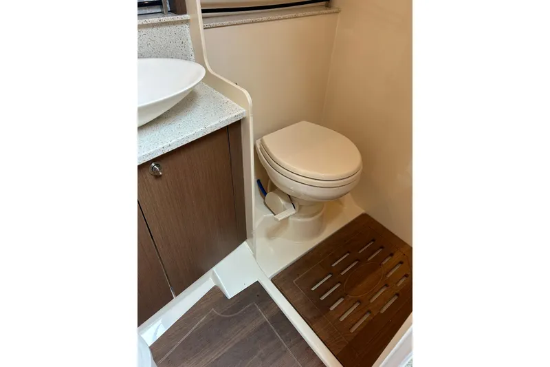 Slide: The Image of 2014 Sea Ray 370 Venture bathroom with modern sink and toilet. - 31