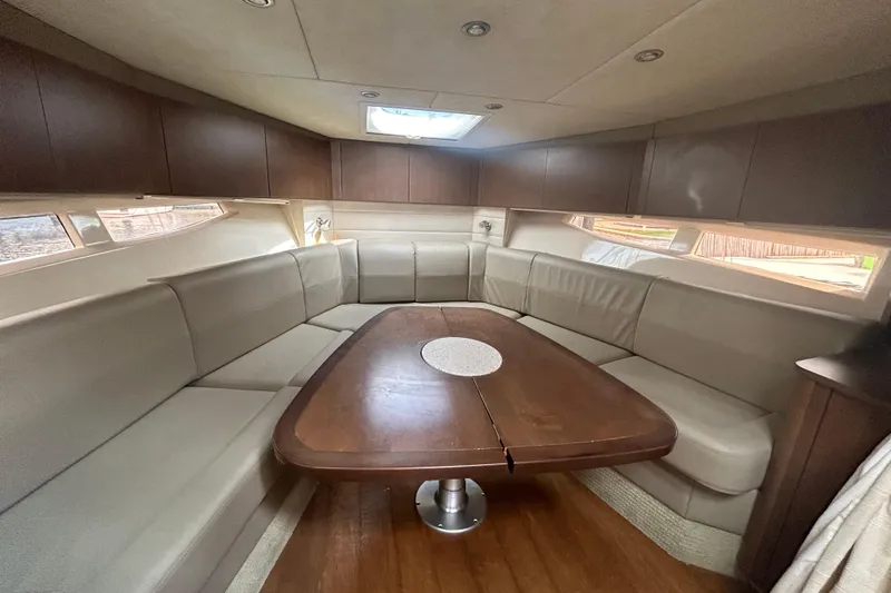 Slide: The Image of Luxurious interior of 2014 Sea Ray 370 Venture yacht with spacious seating and wooden table. - 33