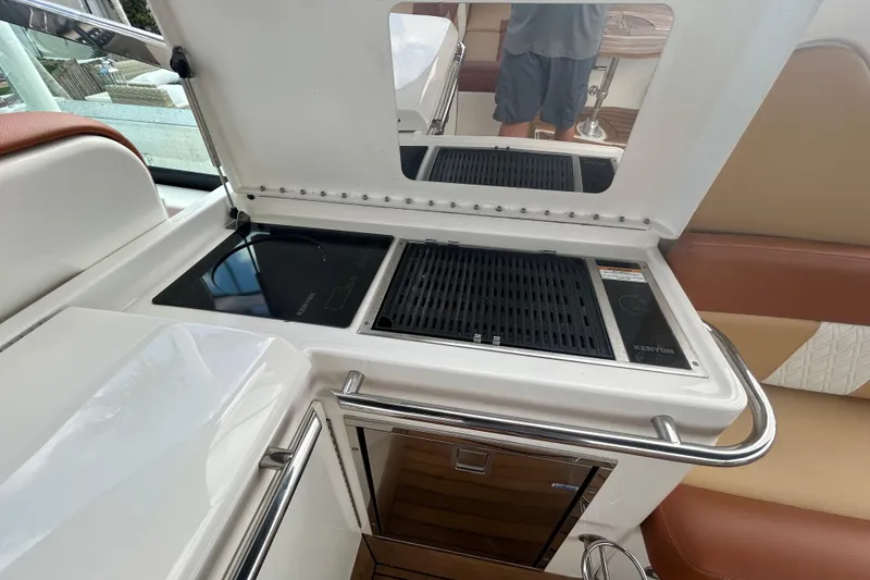 Slide: The Image of 2014 Sea Ray 370 Venture boat kitchen with Kenyon grill and induction cooktop. - 38