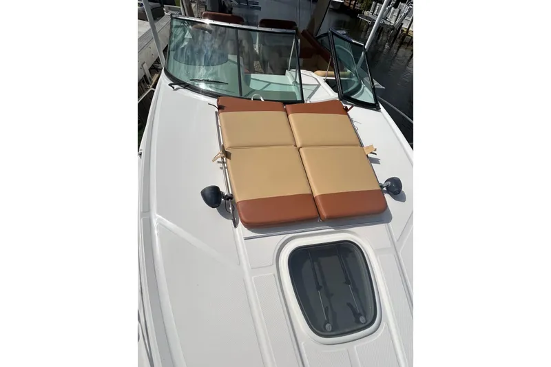 Slide: The Image of 2014 Sea Ray 370 Venture boat with sunpad and windshield, docked at marina. - 44