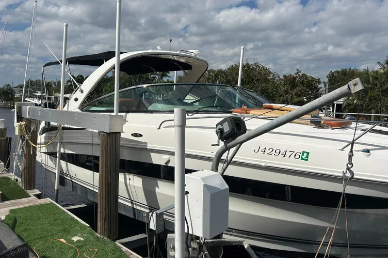 Slide: The Image of 2014 Sea Ray 370 Venture docked under a cloudy sky. - 53