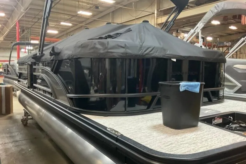 Slide: The Image of 2026 Bennington 23 SSRSF pontoon boat in a warehouse, covered and ready for transport. - 10