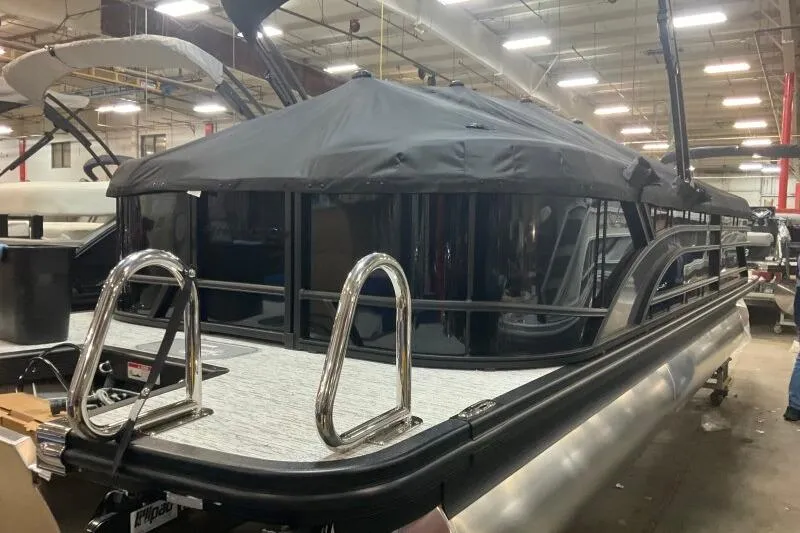 Slide: The Image of 2026 Bennington 23 SSRSF pontoon boat with black canopy in a showroom. - 9