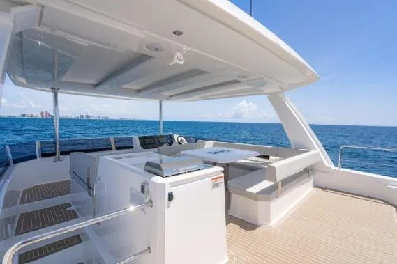 Slide: The Image of 2024 Leopard 40 Powercat yacht deck with seating, ocean view, and clear blue sky. - 10