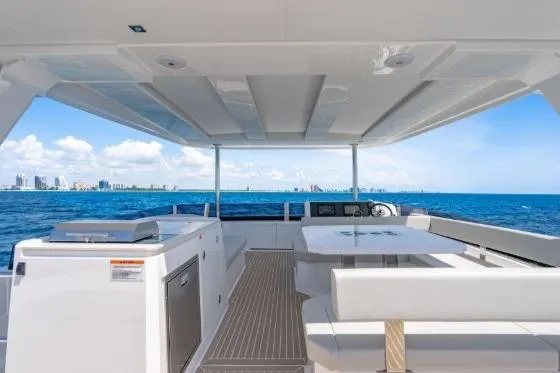 Slide: The Image of 2024 Leopard 40 Powercat yacht interior with ocean view, featuring modern seating and amenities. - 11