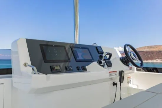 Slide: The Image of 2024 Leopard 40 Powercat helm with modern navigation controls and steering wheel. - 12