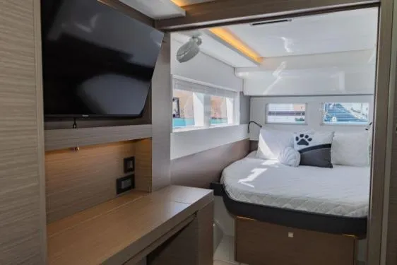 Slide: The Image of 2024 Leopard 40 Powercat cabin with bed, TV, and modern interior design. - 19