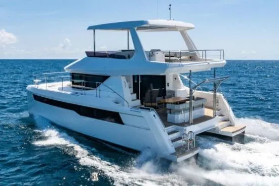 Slide: The Image of 2024 Leopard 40 Powercat cruising on open sea under clear blue sky. - 2