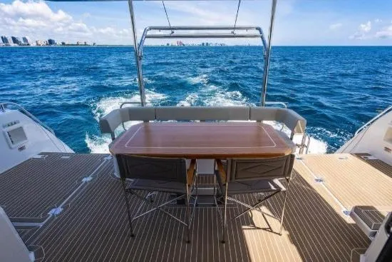 Slide: The Image of 2024 Leopard 40 Powercat yacht deck with ocean view and dining table. - 5