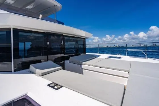 Slide: The Image of 2024 Leopard 40 Powercat yacht with spacious deck and luxurious seating, cruising on a sunny day. - 7