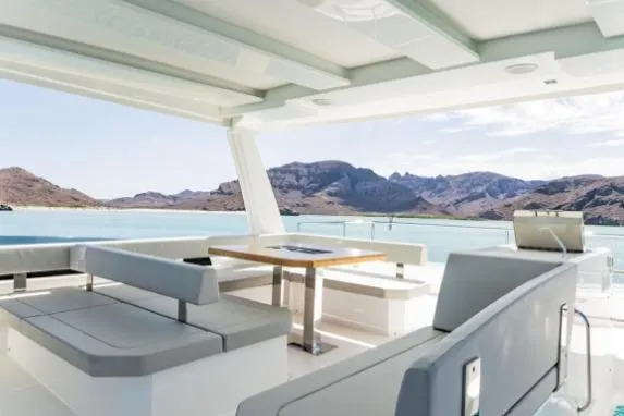 Slide: The Image of 2024 Leopard 40 Powercat interior with scenic ocean and mountain views. - 8