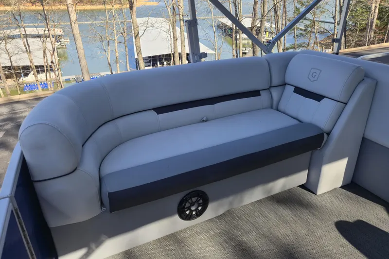 Slide: The Image of Luxurious seating on 2022 Godfrey Sweetwater 2286 SB pontoon boat, overlooking serene marina. - 12
