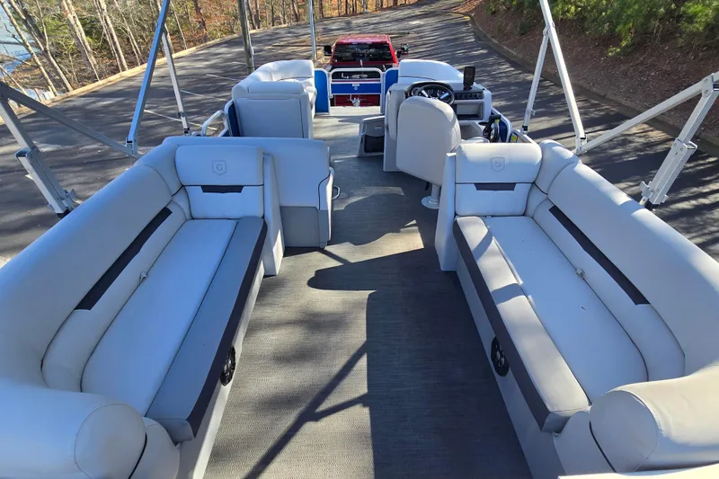 Slide: The Image of 2022 Godfrey Sweetwater 2286 SB pontoon boat interior with spacious seating and steering console. - 13