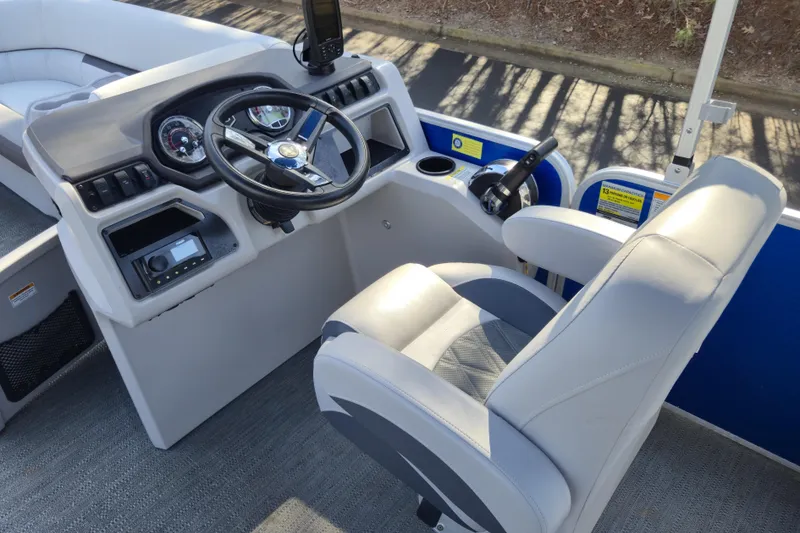 Slide: The Image of 2022 Godfrey Sweetwater 2286 SB boat interior with steering console and captain's chair. - 14