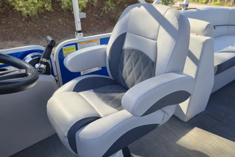 Slide: The Image of Captain's chair on 2022 Godfrey Sweetwater 2286 SB pontoon boat, featuring plush upholstery. - 15