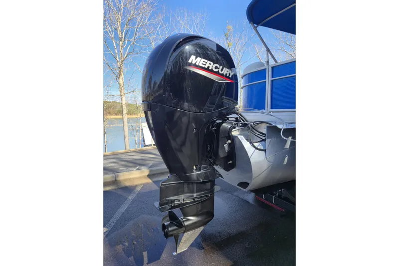 Slide: The Image of 2022 Godfrey Sweetwater 2286 SB with Mercury outboard motor by a lake. - 17