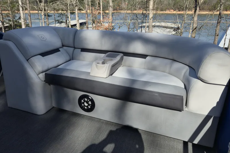 Slide: The Image of 2022 Godfrey Sweetwater 2286 SB boat interior with gray seating and cup holder. - 9