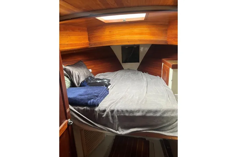 Slide: The Image of Cozy cabin interior of 1979 Downeaster 38 sailboat with wooden paneling and skylight. - 11
