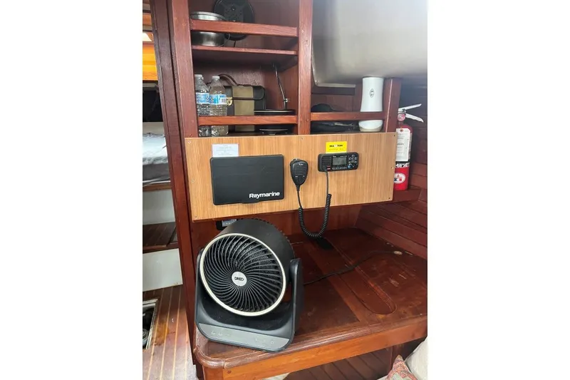 Slide: The Image of 1979 Downeaster 38 interior with navigation equipment and fan. - 14