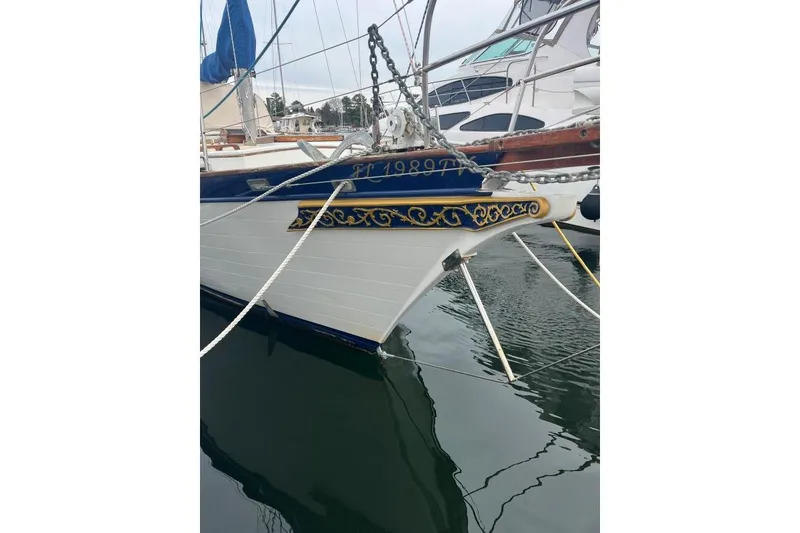 Slide: The Image of 1979 Downeaster 38 sailboat with decorative bow design docked in marina. - 3