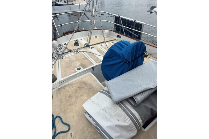 Slide: The Image of 1979 Downeaster 38 sailboat deck with ropes and covered equipment. - 6