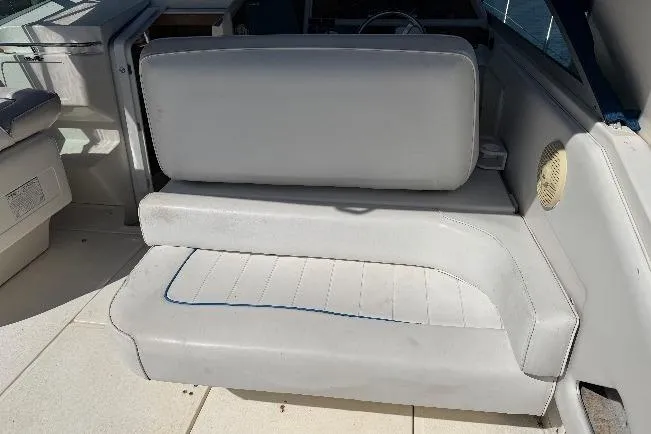 Slide: The Image of 1994 Sea Ray 370 Express Cruiser interior seating, featuring white cushioned bench. - 10