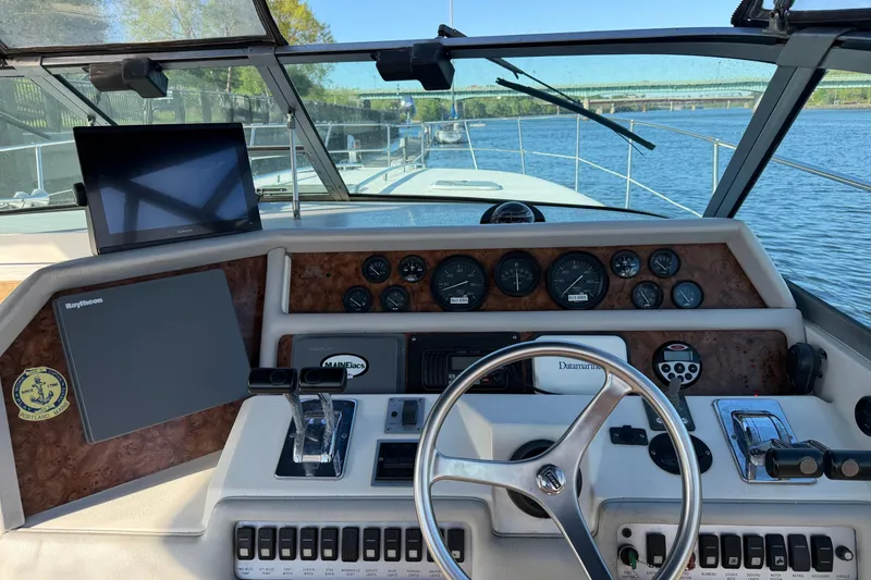 Slide: The Image of 1994 Sea Ray 370 Express Cruiser interior with plush seating and striped cushions. - 11