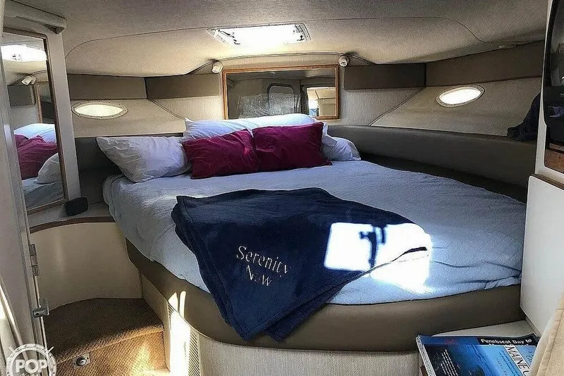 Slide: The Image of Cozy cabin interior of 1994 Sea Ray 370 Express Cruiser with plush bedding. - 7