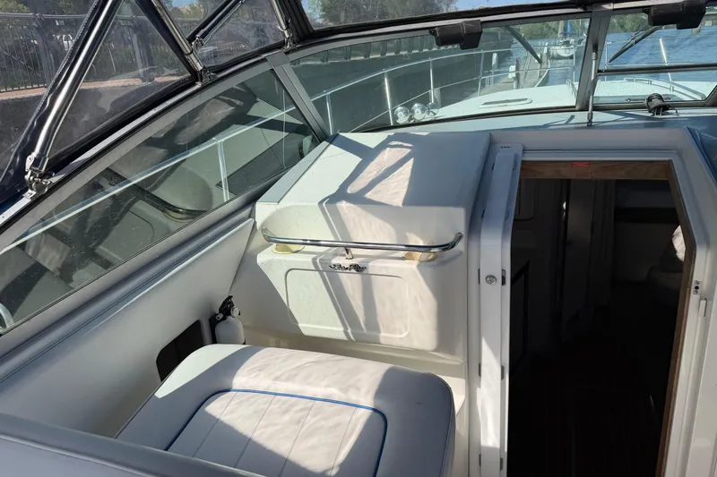 Slide: The Image of 1994 Sea Ray 370 Express Cruiser interior with seating and cabin entrance. - 8