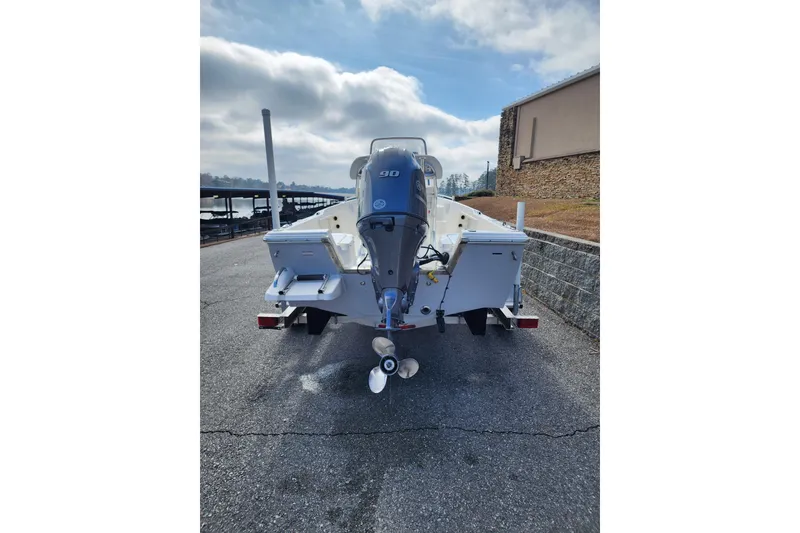 Slide: The Image of 2022 KEYWEST 1720 boat with outboard motor on trailer, parked near marina. - 4