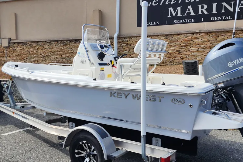 Slide: The Image of 2022 KEYWEST 1720 boat on trailer, displayed at a marina with Yamaha outboard motor. - 5