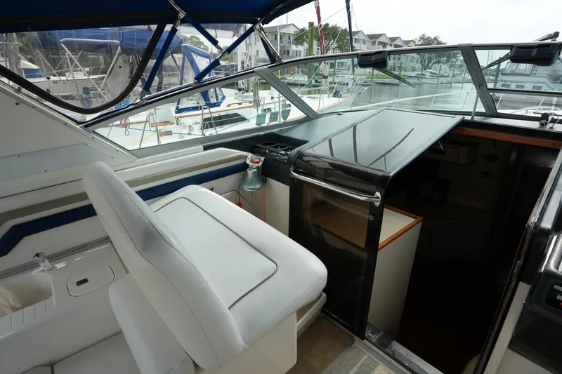 Slide: The Image of 1993 Sea Ray 400 Express Cruiser cockpit with helm seat and marina view. - 11